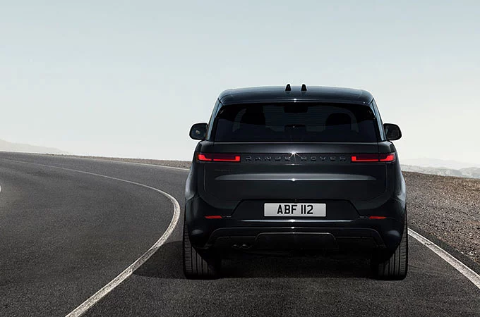 Back view of Range Rover Sport parked on road