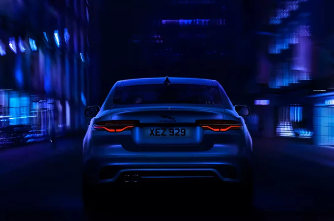 The rear angle of a Jaguar XE as it drives through a city