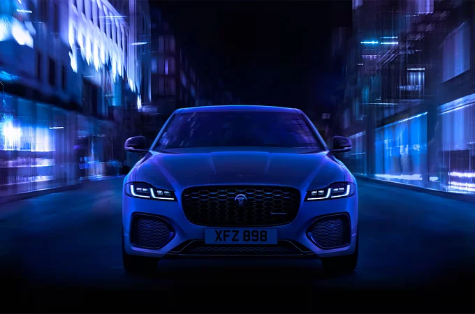 The front angle of a Jaguar XF as it drives through a city