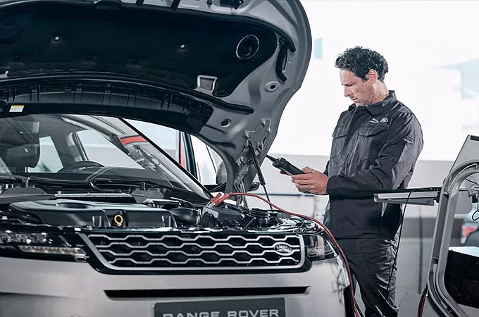 A person checking car in Land Rover Service center