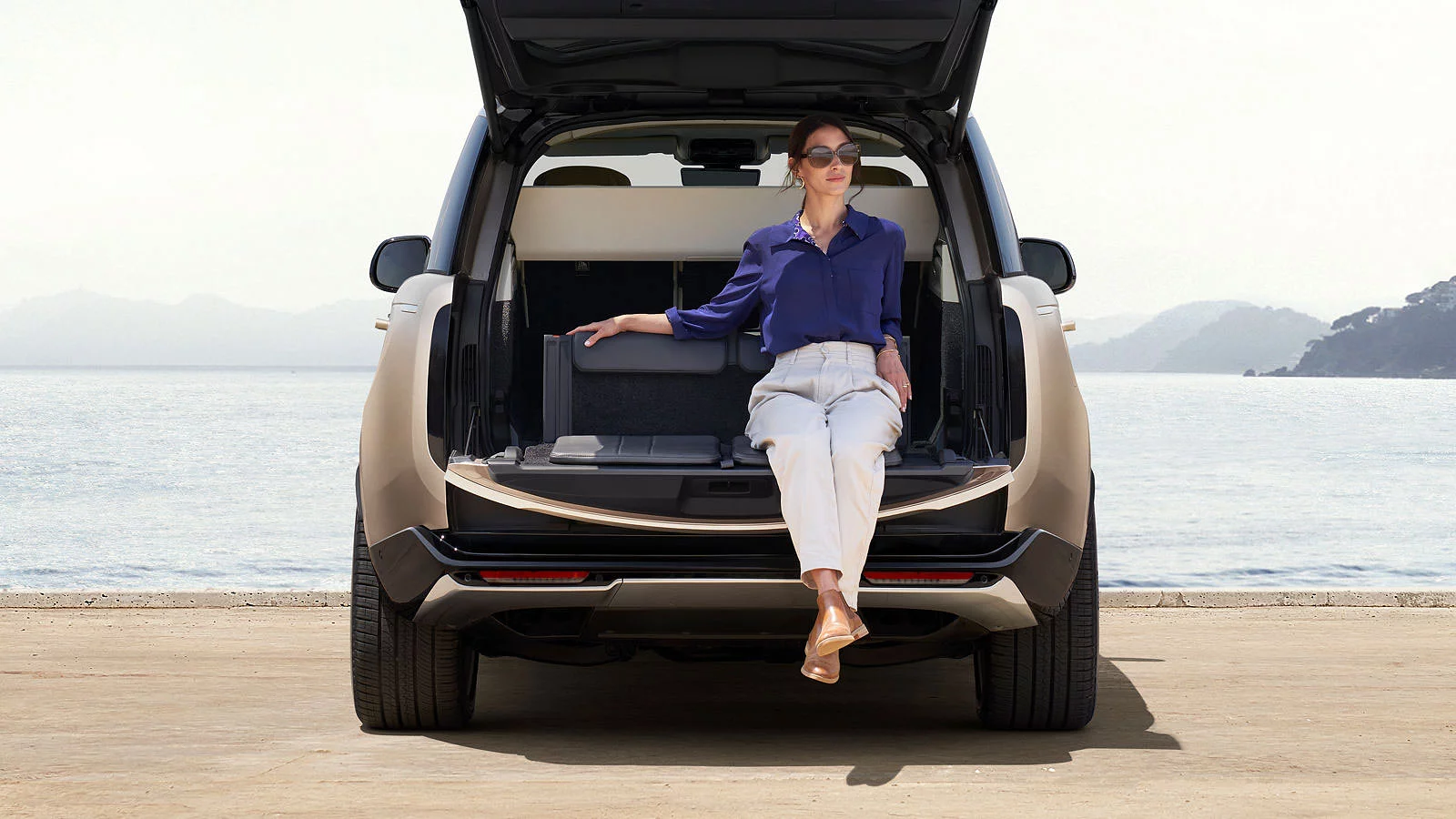 Woman sitting in the trunk of a car