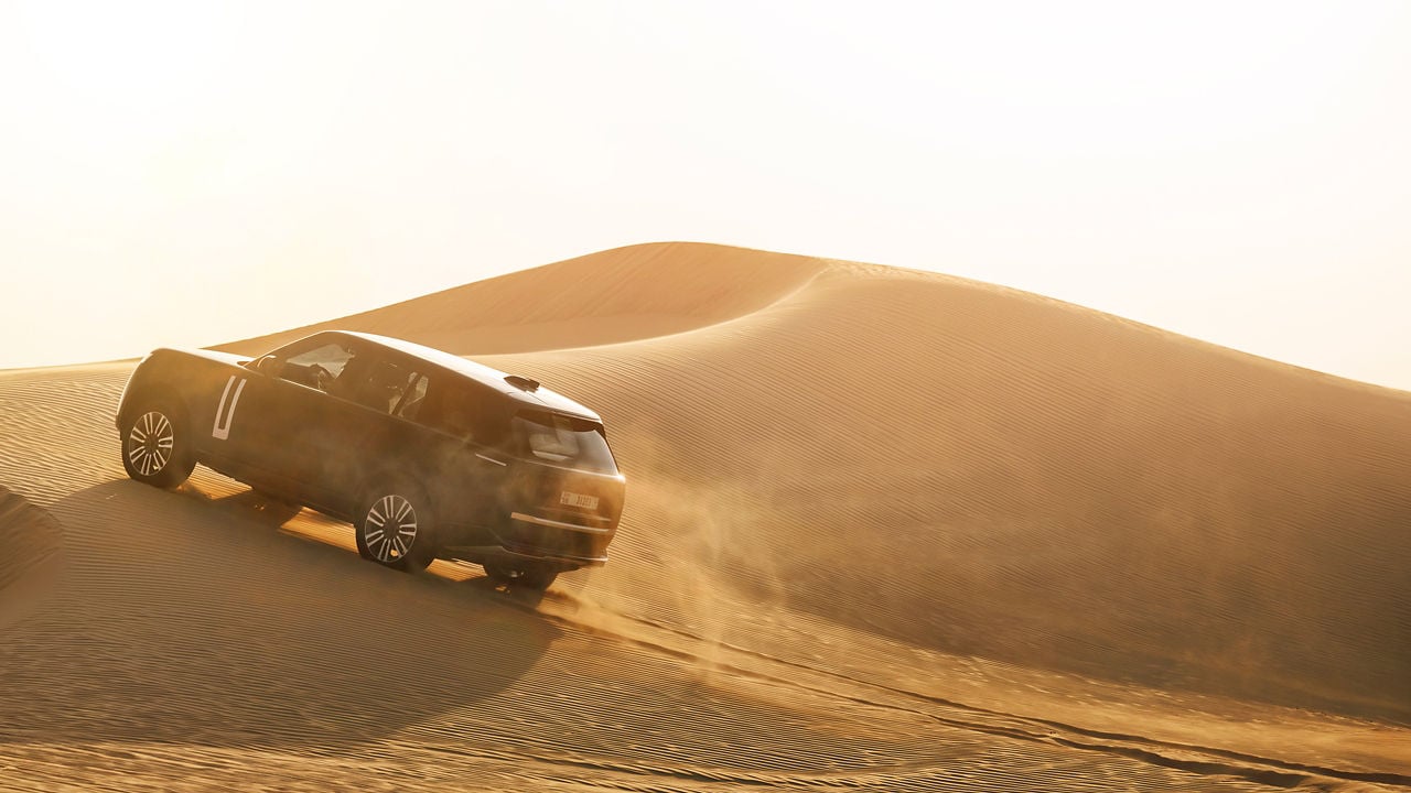 Range Rover Driving on Desert Road