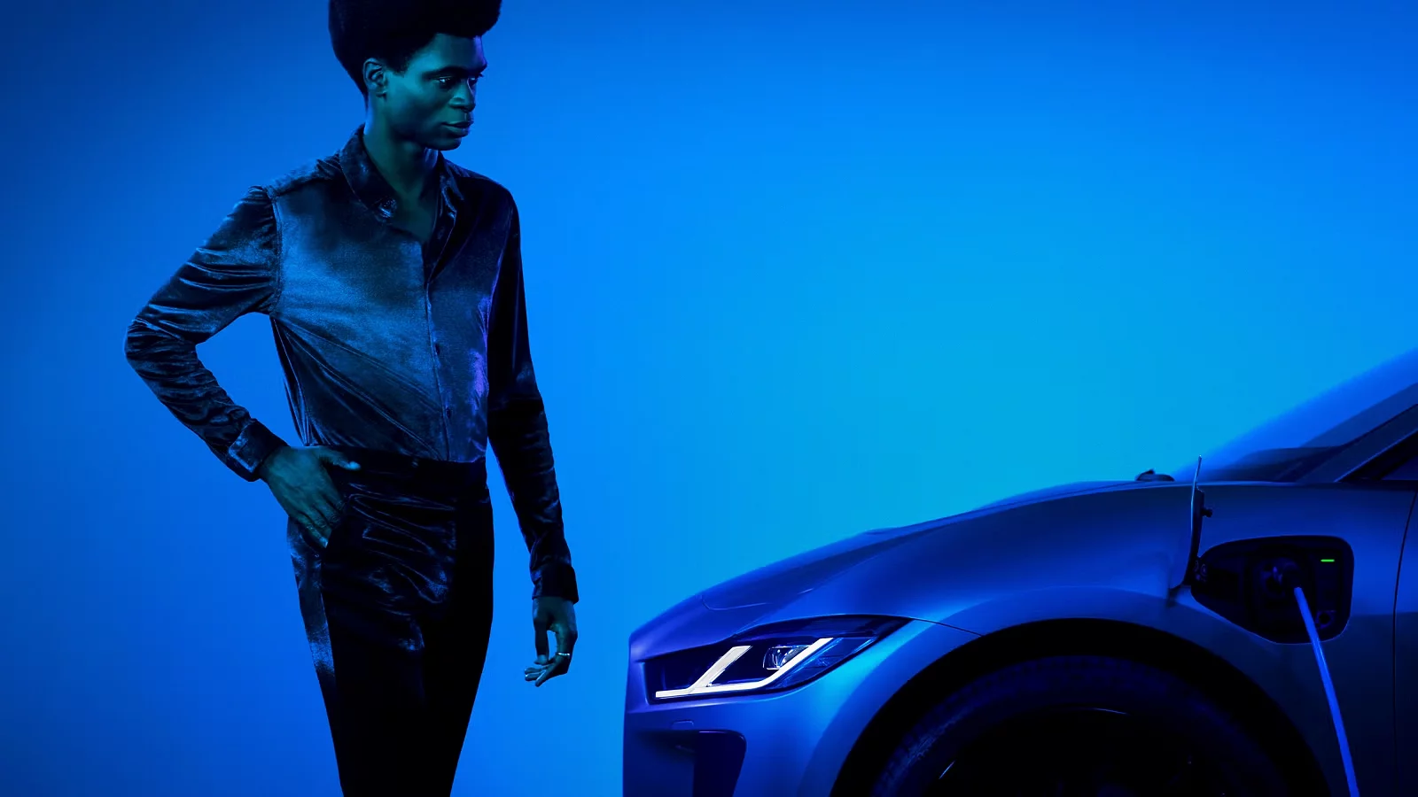 Jaguar I-PACE a male model looking at the car