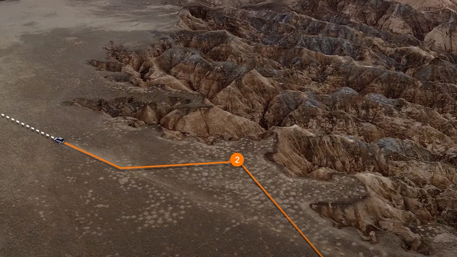 An SUV sweeps across vast desert dunes, expressing effortless capability and modern, refined adventure.