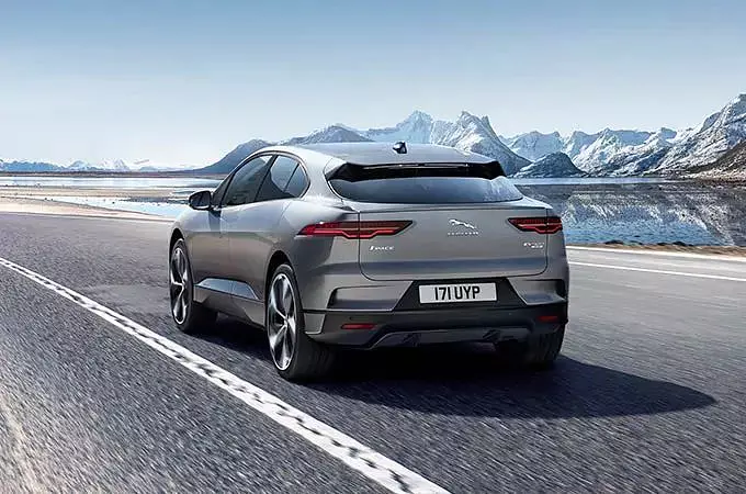 Jaguar I-Pace running on the road and with ice mountain background 
