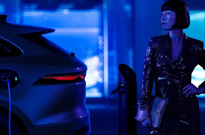 Unidentified beautiful young model standing beside Jaguar F-Pace car