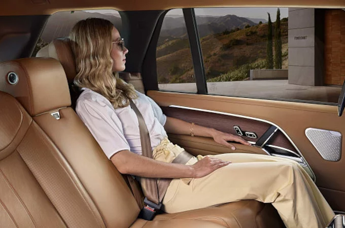 Woman sitting in the New Range Rover with light brown interior