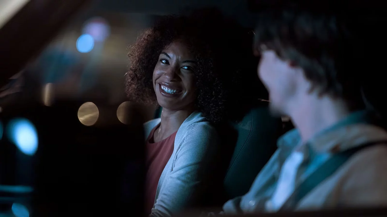 Smiling girl sitting in the car