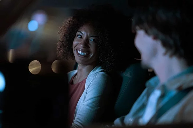 Smiling girl sitting in the car