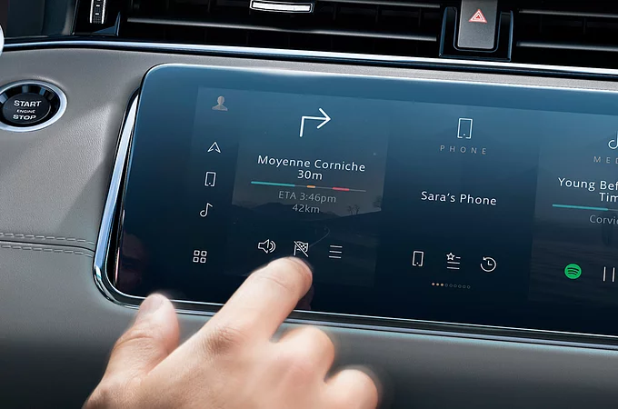 Close up mans hand select the application of navigation or maps on the car dashboard